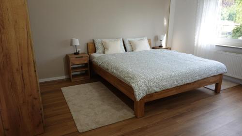 a bedroom with a bed with pillows and a window at FeWo Kalletal in Kalletal