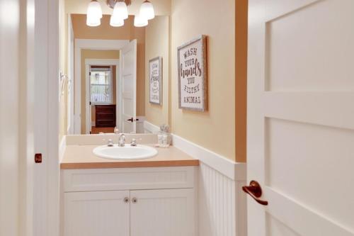 a bathroom with a sink and a mirror at Sunny Getaway at Veranda Beach in Oroville