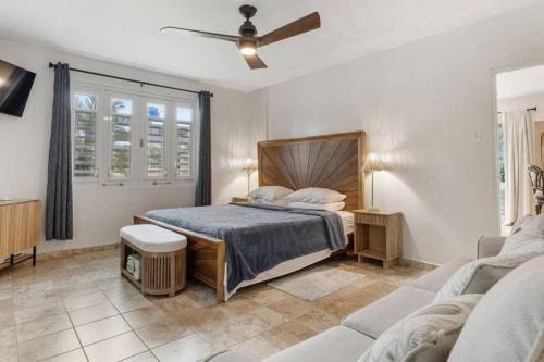 a bedroom with a bed and a couch at Ocean Vibes near Rincón Beachfront Access Condo in Matias
