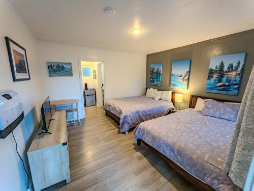 a hotel room with two beds and a flat screen tv at The Chalet at Kings Beach Unit 2 in Kings Beach