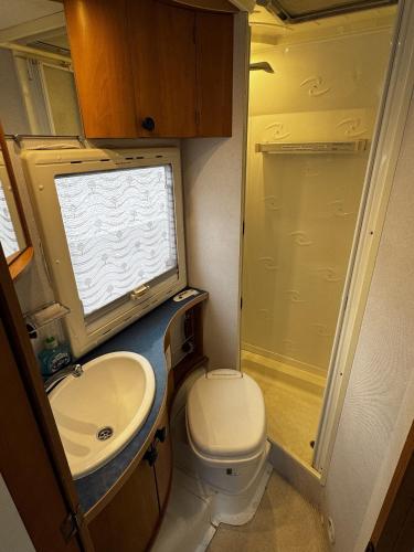 a small bathroom with a toilet and a sink at Rover Rentals in Inverness