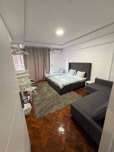 a living room with two beds and a couch at Hotel Campo Pequeno in Lisbon