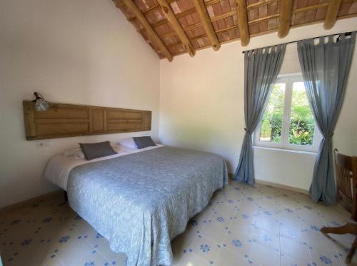 a bedroom with a bed and a window at La Escribana in Constantina