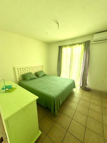 a bedroom with two beds and a window at Sxm Caribbean Nest in Saint Martin