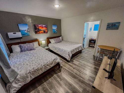 a hotel room with two beds and a table at The Chalet at Kings Beach Unit 6 in Kings Beach