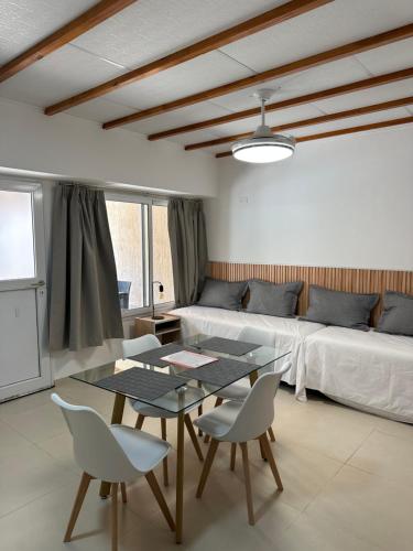 a living room with a couch and a table and chairs at Etel Departamentos in San Rafael