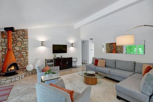 a living room with a couch and a fireplace at Alejo Olive Orchard - Alice Lodging in Palm Springs