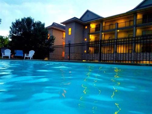 a large swimming pool in front of a house at The Retreats at Stone Fountain in Arnolds Park