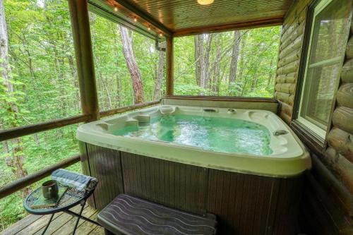 a jacuzzi tub in a cabin in the woods at Havenwood in Logan