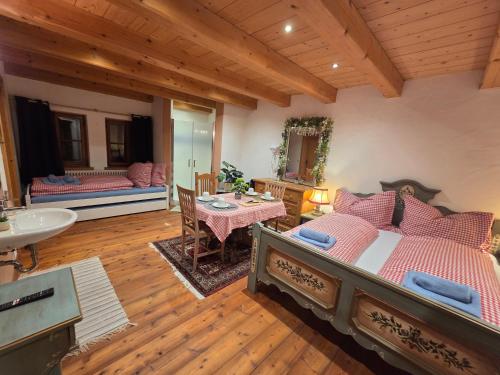 a bedroom with a bed and a sink and a table at Sonnleit'n Zimmer 7 in Abtenau