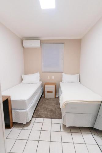 a room with two beds and a tv in it at REFÚGIO FAMILIAR Jampa JP in João Pessoa