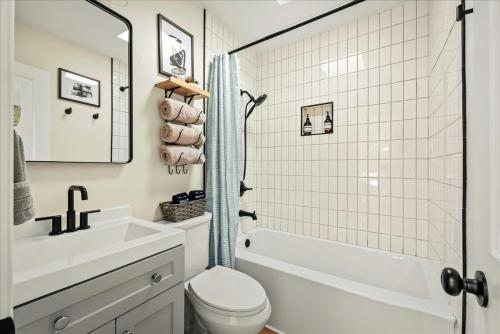 a bathroom with a sink and a toilet and a tub at Cozy Pocono Retreat in Tobyhanna