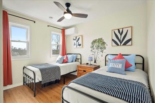a bedroom with two beds and a ceiling fan at Cozy Pocono Retreat in Tobyhanna