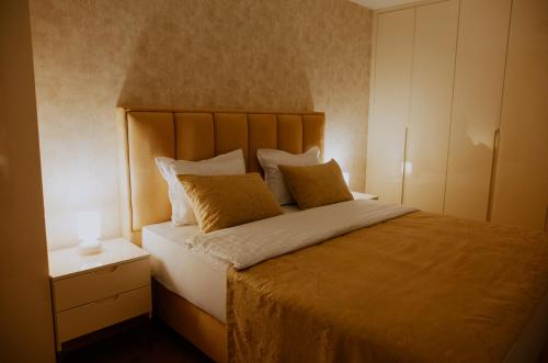 a bedroom with a large bed with two pillows at Apartman Djurić in Brčko