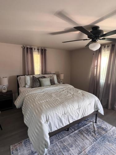 a bedroom with a bed with a ceiling fan at Skipper Apt #4 in Rockingham