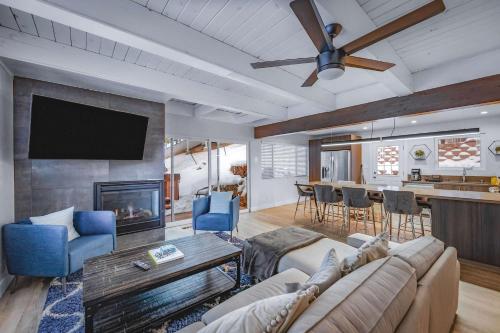 a living room with a couch and a ceiling fan at Zephyr Chalet Steps from Zephyr Cove in Glenbrook