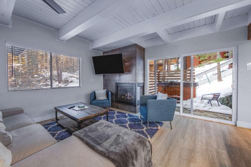 a living room with a couch and a fireplace at Zephyr Chalet Steps from Zephyr Cove in Glenbrook