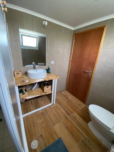 a bathroom with a sink and a toilet at Villa Pico de Mafra in Mosteiros