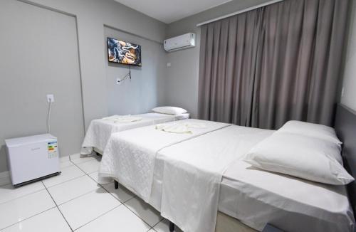 a hospital room with two beds and a window at GB Hotéis Foz Centro in Foz do Iguaçu