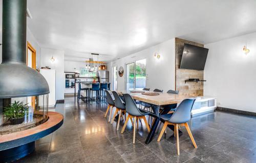 a kitchen and dining room with a table and chairs at Lovely Home In Lanvéoc in Lanvéoc