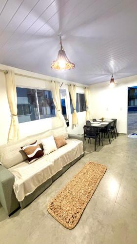 a bedroom with a bed and a dining room with a table at Maramar Beach House in Luis Correia