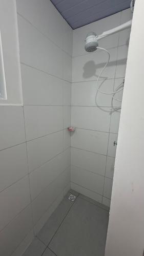 a white shower with a light on the wall at Maramar Beach House in Luis Correia