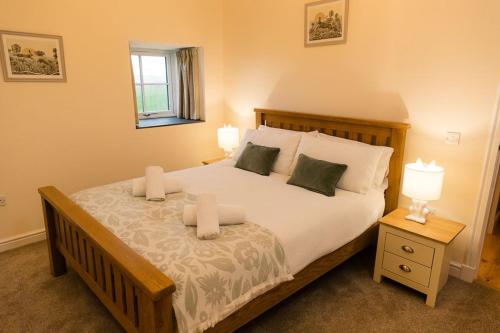 a bedroom with a large bed with two lamps at Dale, Burray, Orkney - OR00597F in Burray Village