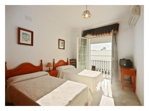 Postel nebo postele na pokoji v ubytování Hostal La Posada