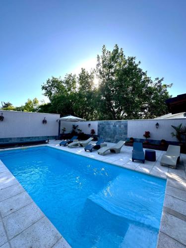 a swimming pool with lounge chairs next to at Etel in San Rafael