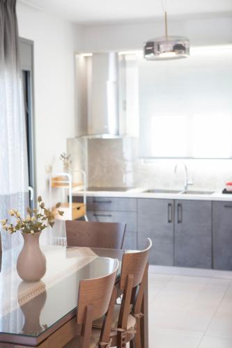 a kitchen with a table with a vase on it at Valora Villa in Nydri
