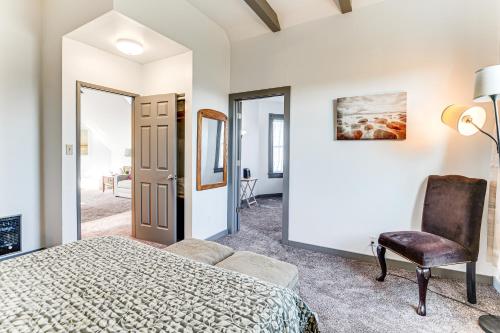 a bedroom with a bed and a chair at Walkable Location, Historic Setting: Warrenton Apt in Warrenton