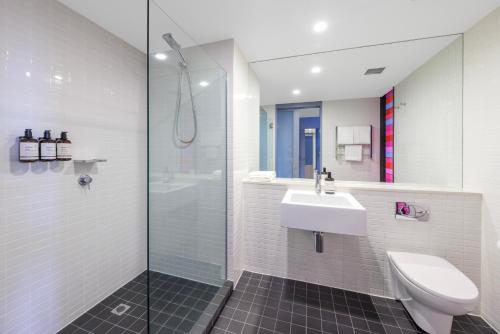 a bathroom with a toilet and a sink and a shower at lyf on Elizabeth Melbourne in Melbourne