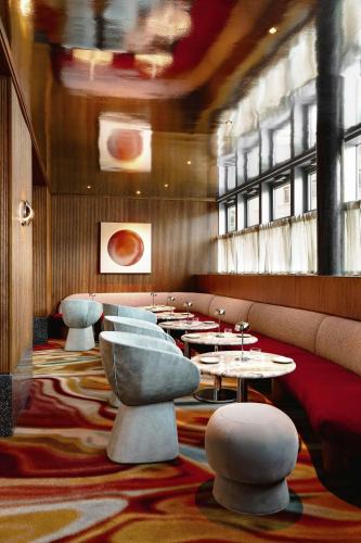 a restaurant with tables and chairs in a room at W Hoboken in Hoboken
