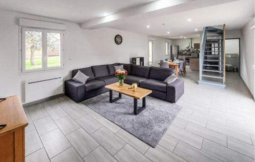 a living room with a couch and a table at Authentique Ferme En Campagne in Saint-Germer-de-Fly