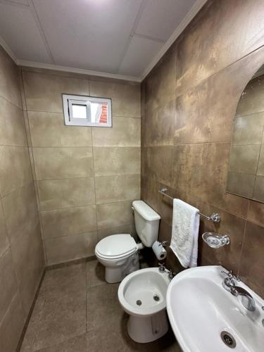 a bathroom with a toilet and a sink at Etel in San Rafael