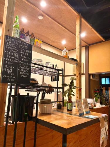 a table with a chalkboard on top of it at GROUNDWORK Guesthouse & Lounge in Yugawara