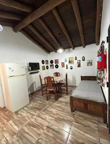 a living room with a refrigerator and a table at AlCarajo in Villa Yacanto
