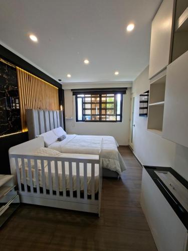 a bedroom with a white bed and a window at Beach House - Besso Beach in Barranca