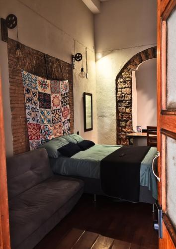 a bedroom with a bed and a couch at Casona Imperial in Tepic