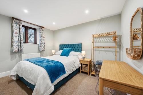 a bedroom with a bed and a desk in it at The Forge in Castleton