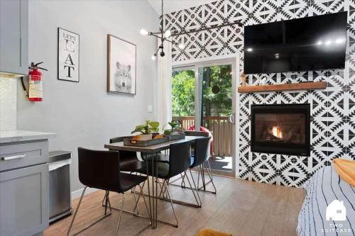 a living room with a table and a fireplace at #LazyBear Tahoe Dreamy Escape in Tahoe Vista