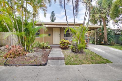a house with palm trees in front of it at 2 Mi to Boardwalk Home with Grill in Dania Beach! in Dania Beach