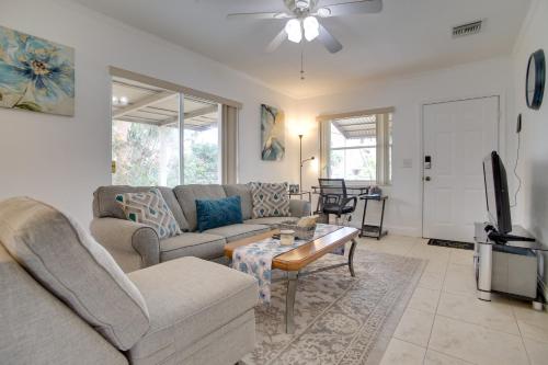 a living room with a couch and a table at 2 Mi to Boardwalk Home with Grill in Dania Beach! in Dania Beach