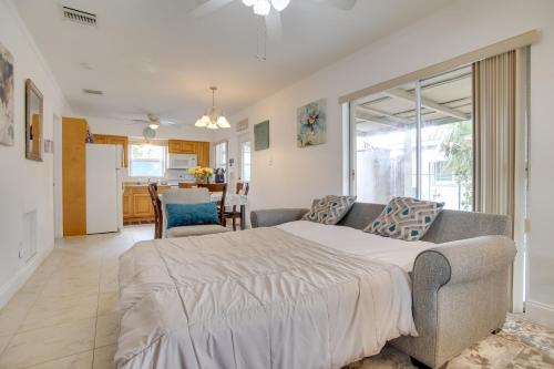 a bedroom with a large bed and a couch at 2 Mi to Boardwalk Home with Grill in Dania Beach! in Dania Beach