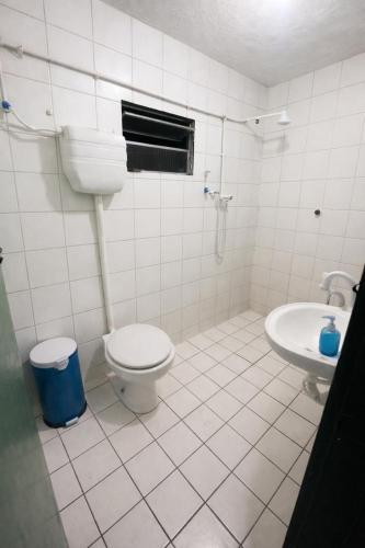 a bathroom with a toilet and a sink at Cantinho do Sol in Recife