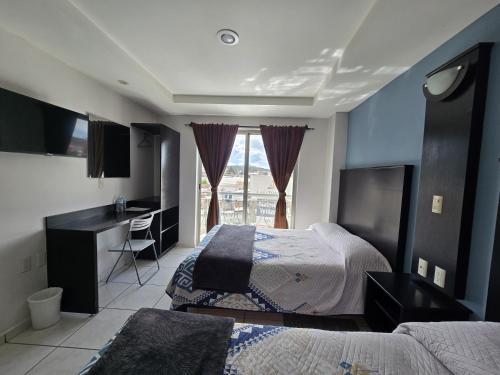 Tempat tidur dalam kamar di Hotel Santa Fe