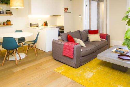 a living room with a couch and a table at Liiiving in Porto | Central Garden Flat in Porto