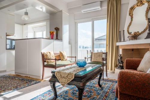 a living room with a table and chairs and a fireplace at Villa Luna in Káto Ássos
