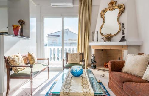 a living room with a couch and a fireplace at Villa Luna in Káto Ássos