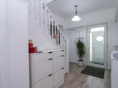 a bathroom with white cabinets and a staircase at Broadgreen in Liverpool